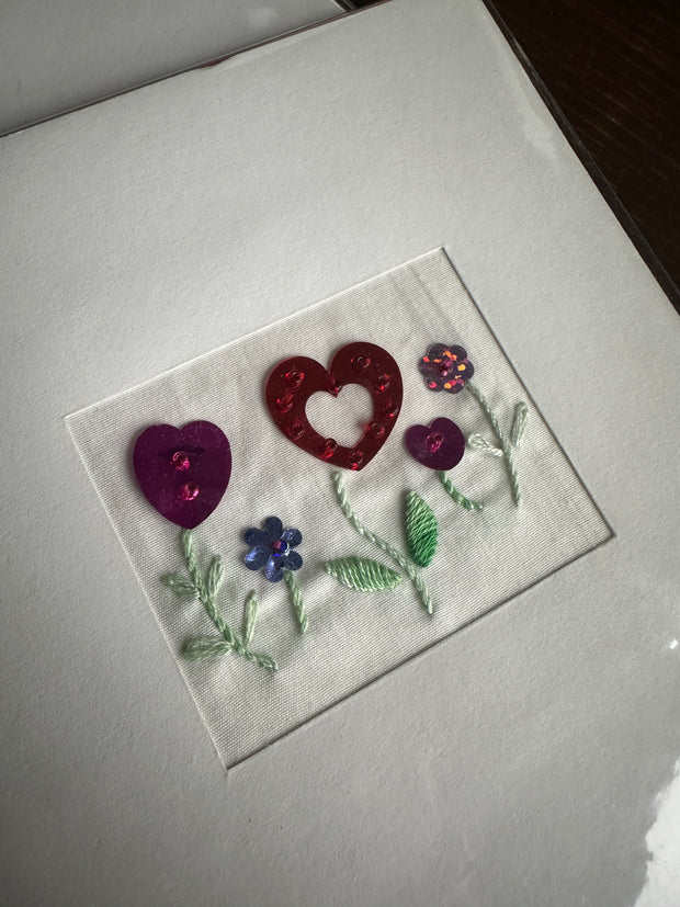 Flower heart. Hand embroidered greeting card.